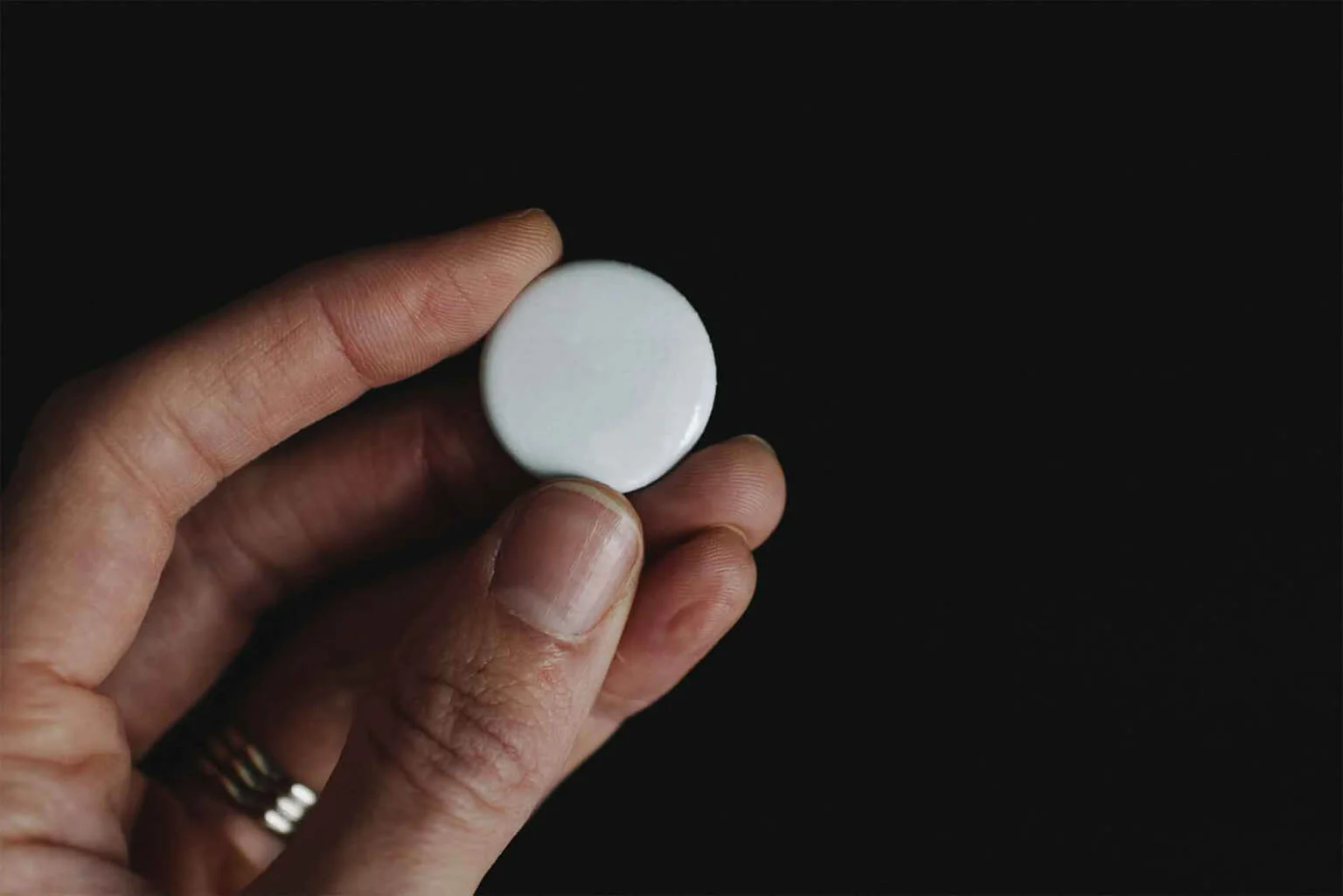 Hand Holding Pin Button Mockup